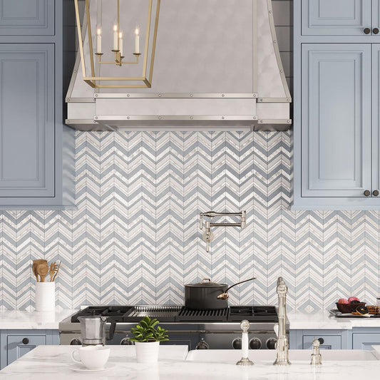 Blue and white marble chevron tile backsplash with Mother of Pearl shell accents