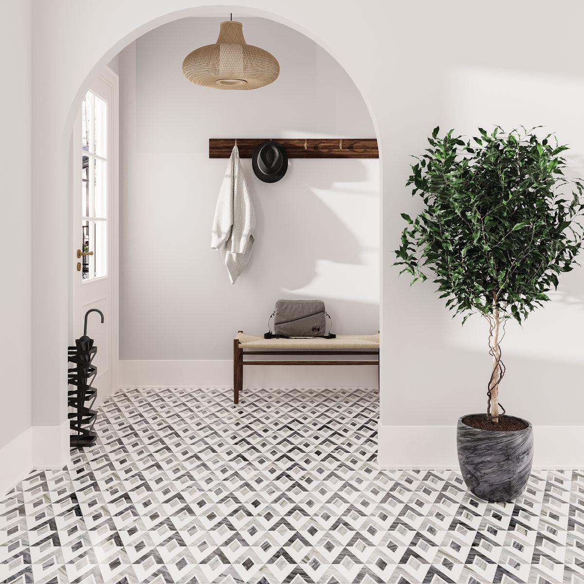 Entryway with an arched doorway and patterned floor tile