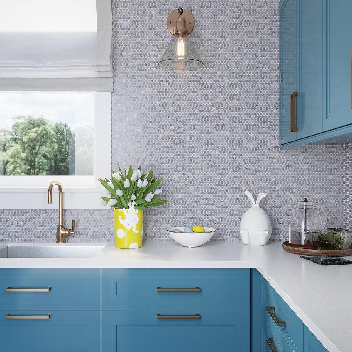 Gray backsplash penny round tile with blue kitchen cabinets