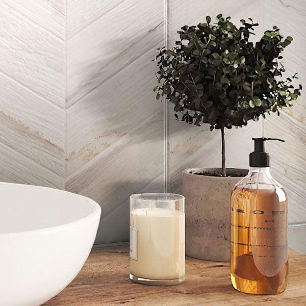 Bathroom Sink and Shampoo on Background of Spiga Olson Blanco Wood-Look Chevron Porcelain Tile