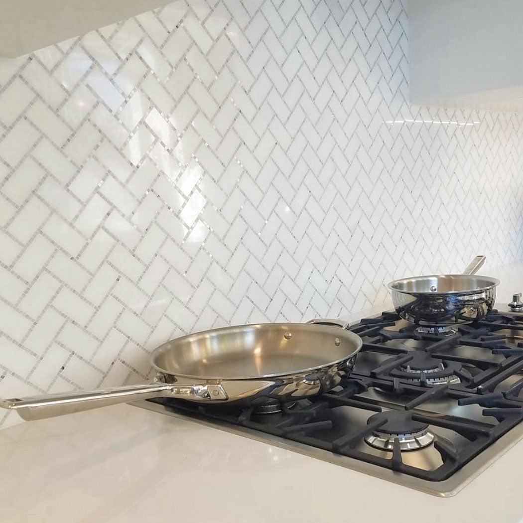Thassos and Carrara Herringbone Marble tile with Mosaic Accents