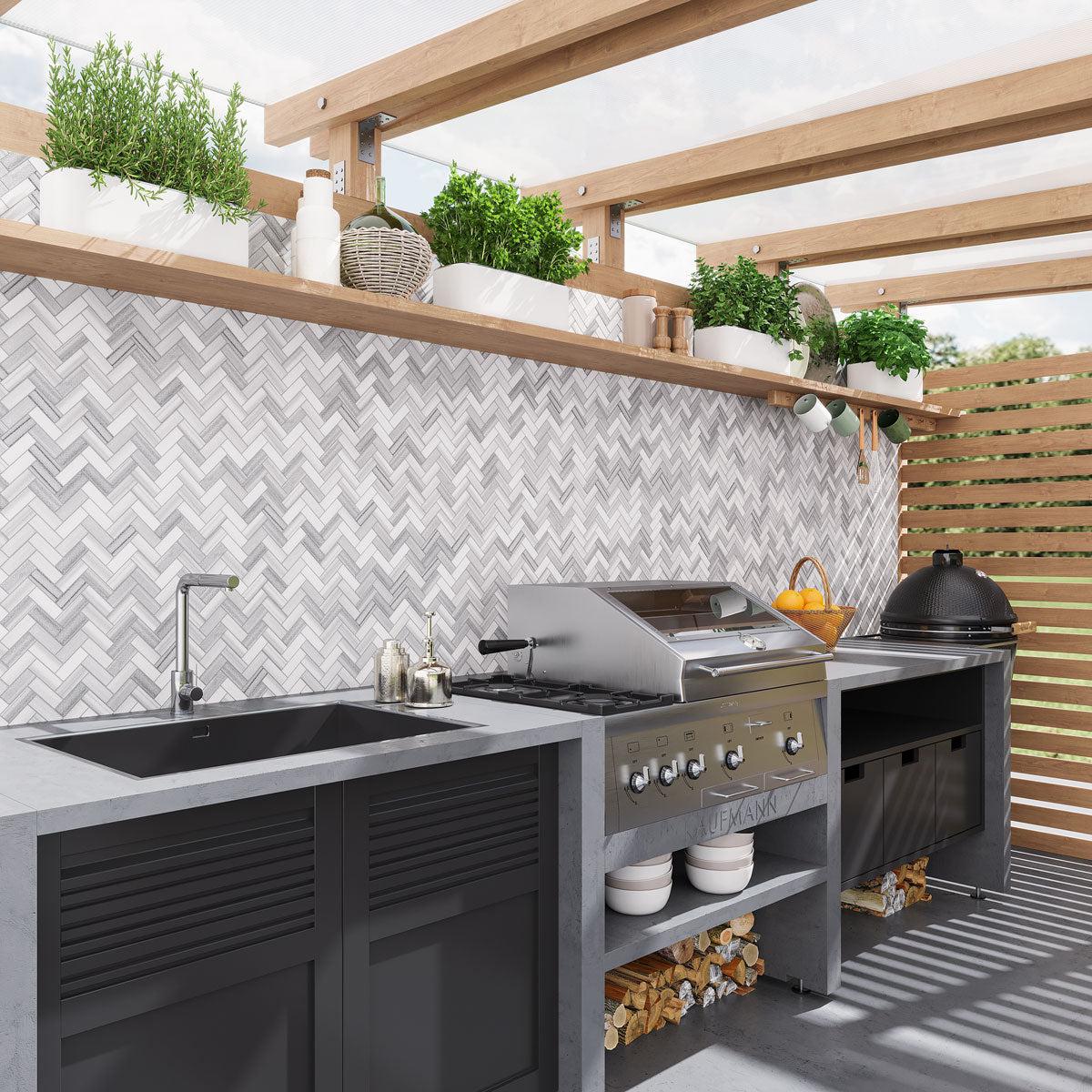 Outdoor kitchen and grill area with Equator Herringbone Polished Mosaic Tile backsplash