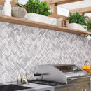 Gray and white herringbone outdoor kitchen backsplash