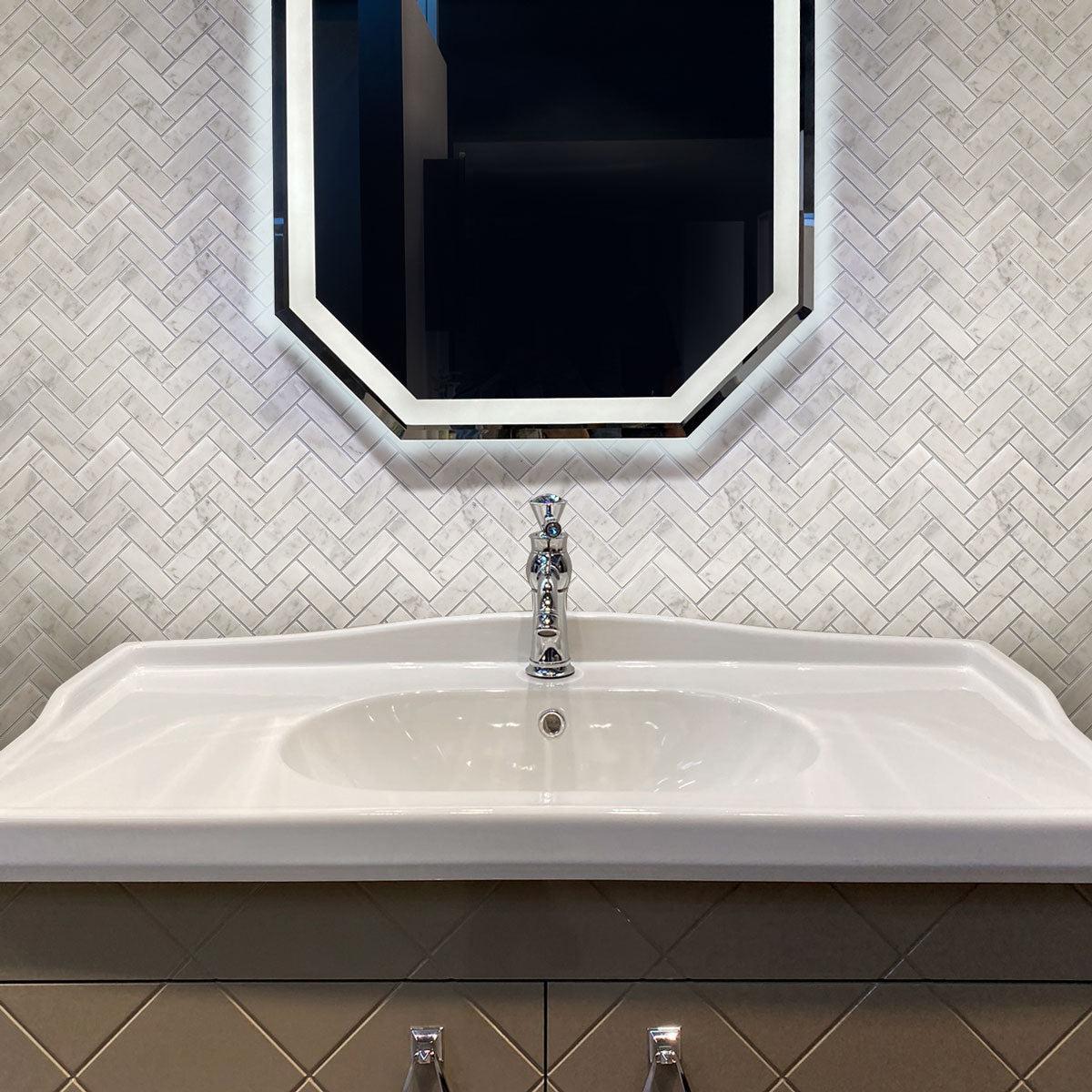 Carrara marble bathroom wall tile with a herringbone pattern