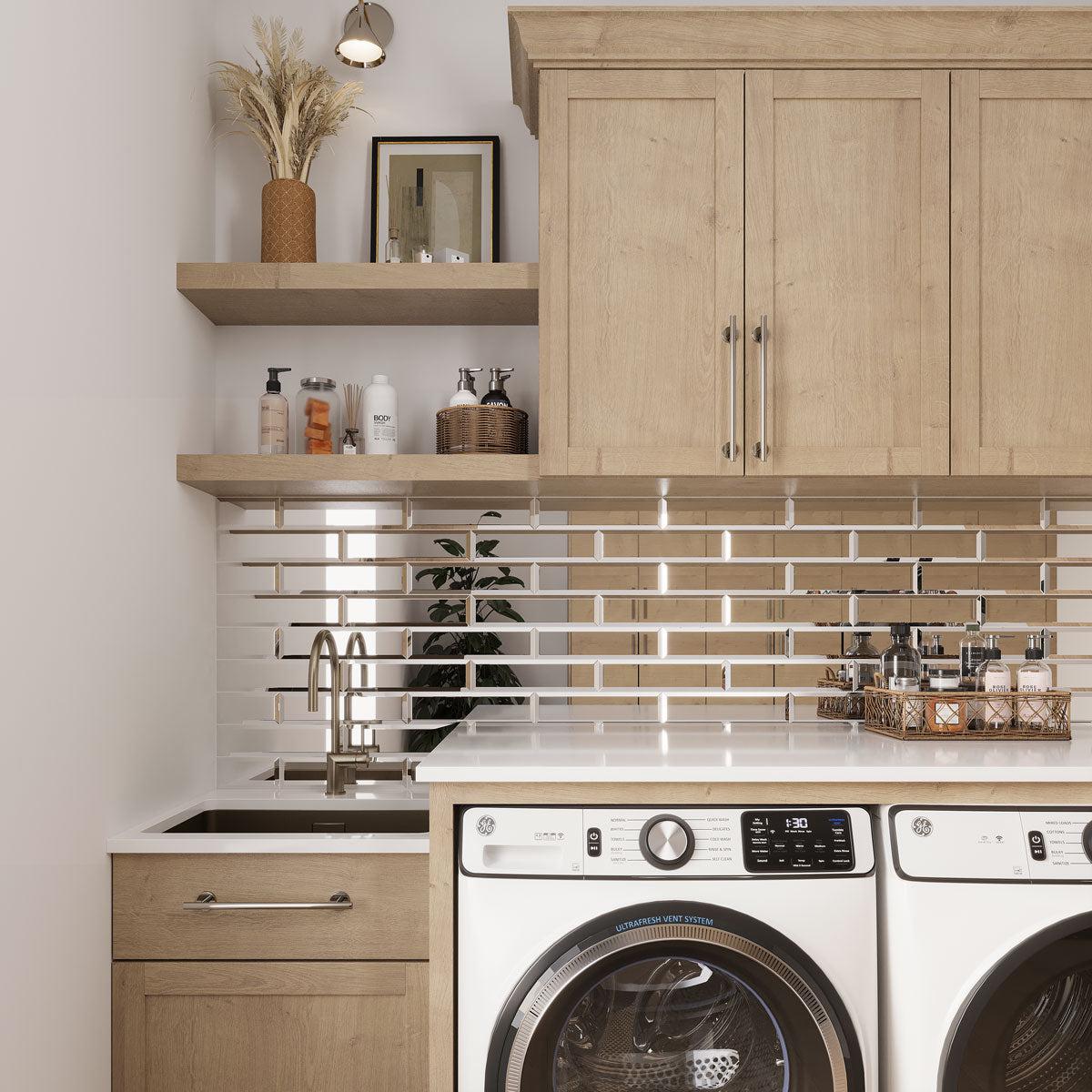 Laundry Room with a mirrored glass subway tile backsplash under natural wood cabinets