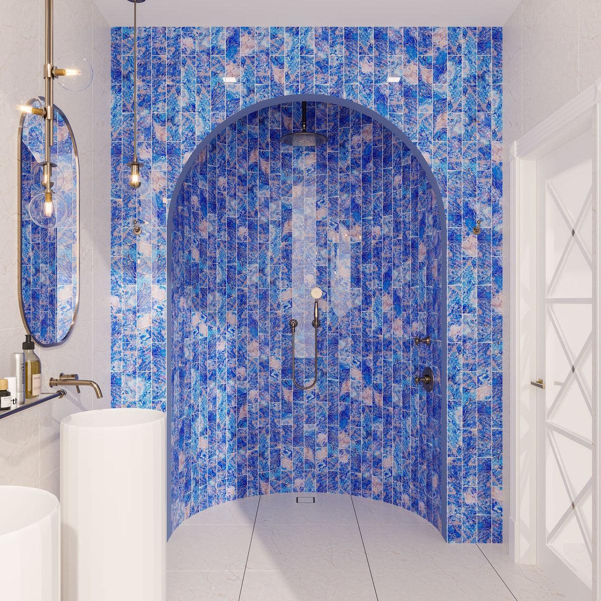 Blue subway tile bathroom shower wall with gemstone pattern