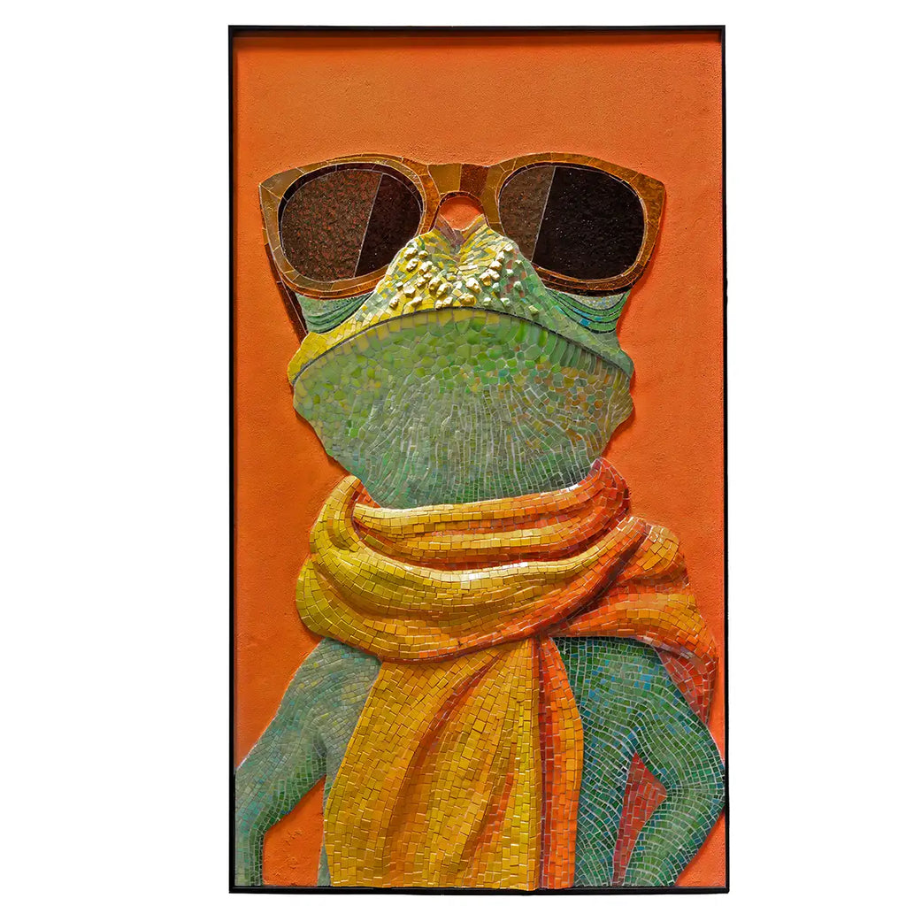 A framed vertical art print depicting a stylized green frog wearing large dark sunglasses and a bright yellow-orange scarf, set against a solid orange background.