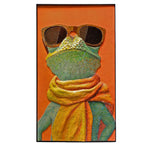 A framed vertical art print depicting a stylized green frog wearing large dark sunglasses and a bright yellow-orange scarf, set against a solid orange background.
