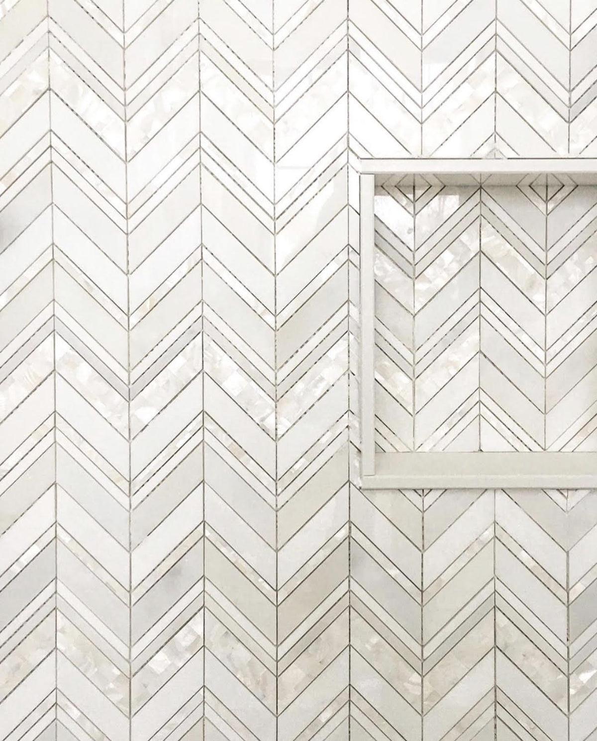 white thassos mosaic tile with pearl herringbone for a modern shower wall and niche