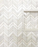 white thassos mosaic tile with pearl herringbone for a modern shower wall and niche