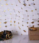 calacatta golden marble and brass tile backsplash