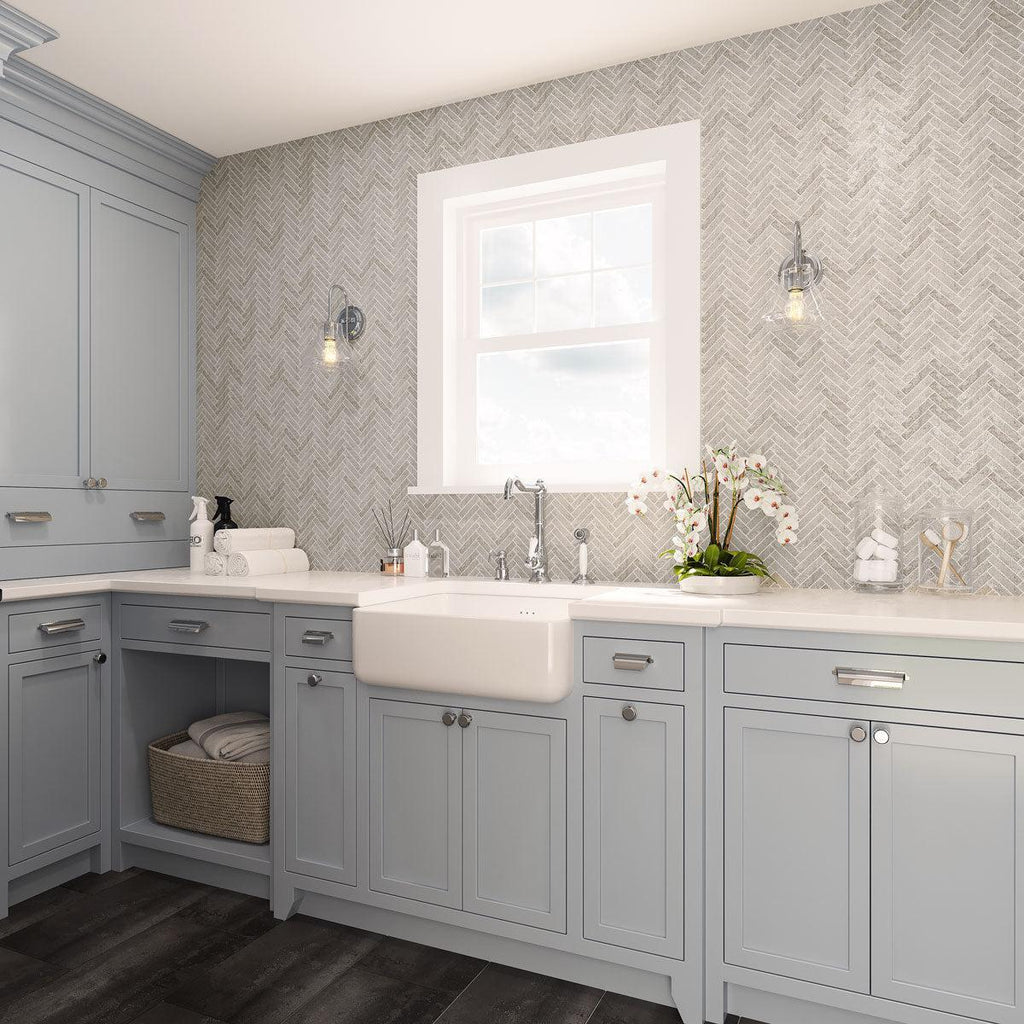 Blue and white laundry room with porcelan herringbone mosaic tiles