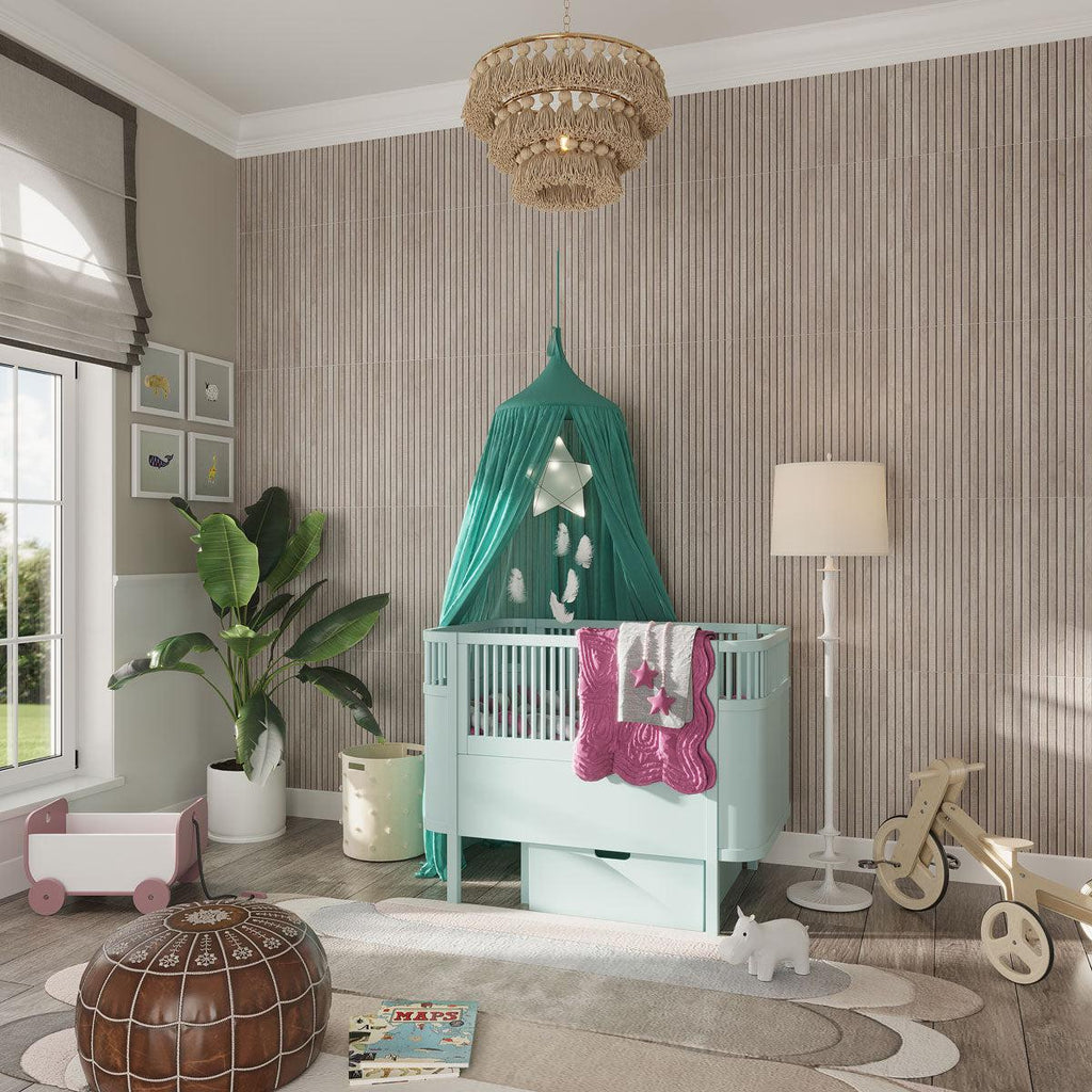 Trendy nursery design with gray slat wall accents