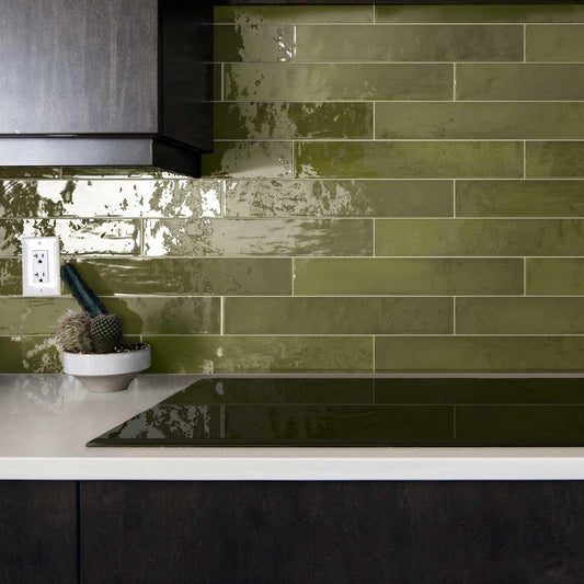 Moody black and green kitchen with glazed square ceramic tile backsplash