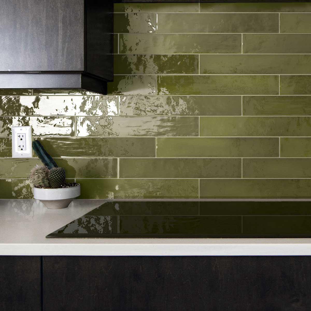 Moody black and green kitchen with glazed square ceramic tile backsplash