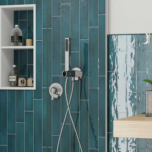 Glazed ceramic subway tiles in bold teal for a colorful shower wall