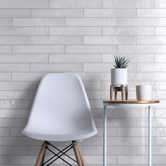 Wall tile installation with glazed white long subway tiles