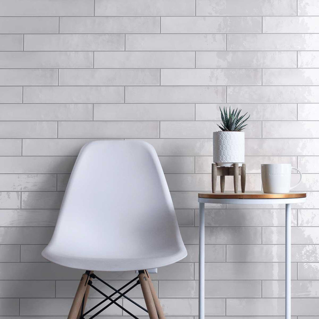 Wall tile installation with glazed white long subway tiles