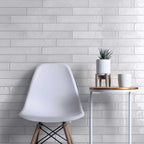 Wall tile installation with glazed white long subway tiles