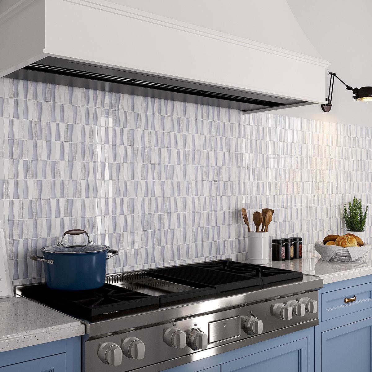 Blue and white kitchen with Moongrey Triangle Glass Mosaic Tile backsplash over the gas stove