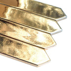 Several gold ceramic tiles close-up