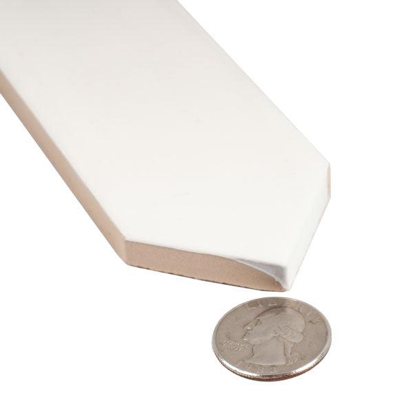 White ceramic tile close-up with coin