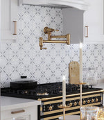 White Encaustic Tile Backsplash with Gold and Black Fixtures
