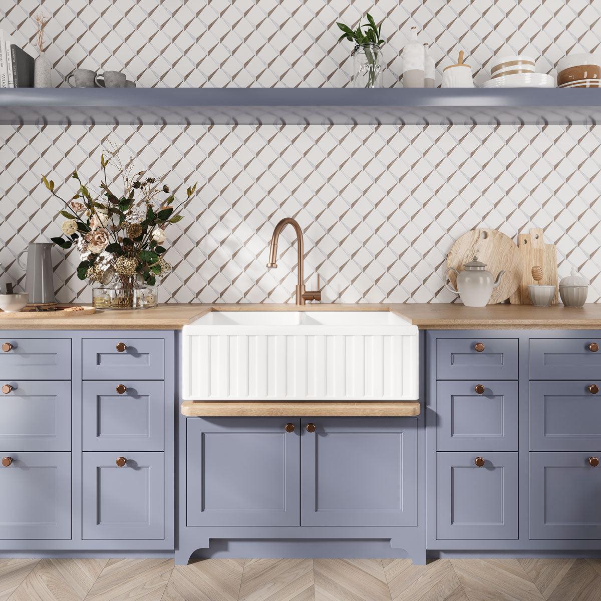 Blue and white kitchen with patterned marble tiles