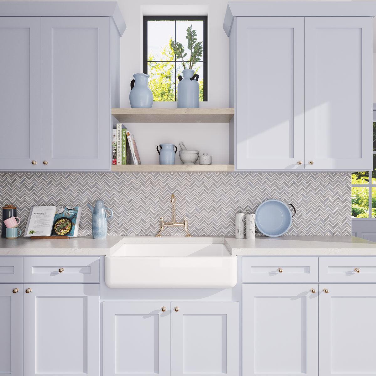 Blue and white kitchen with marble chevon mosaic tile