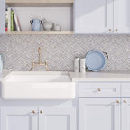 Blue and white farmhouse kitchen with chevron marble tiles