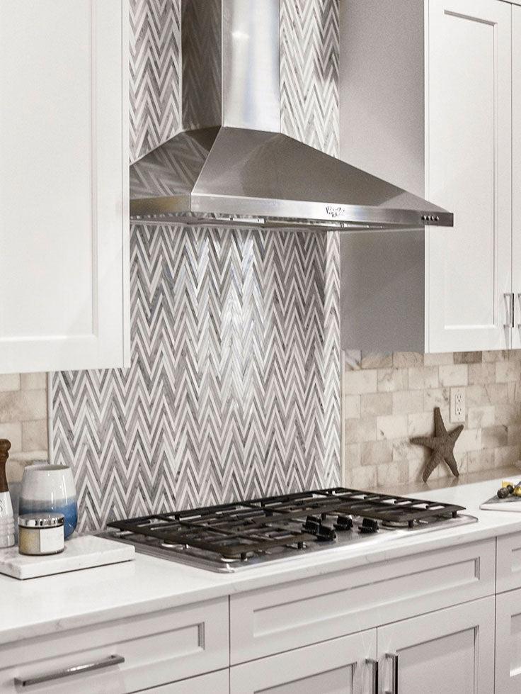 Azul Cielo Thassos And Carrara Striped Chevron Mosaic Tile Behind the Stove with Marble Subway Tile