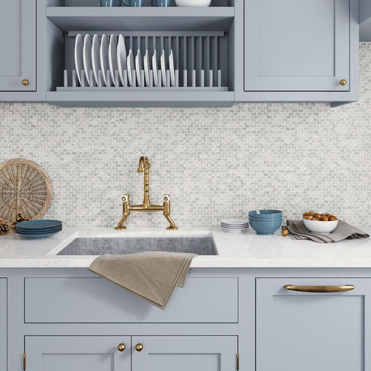 Blue kitchen cabinets with white marble tile kitchen backsplash