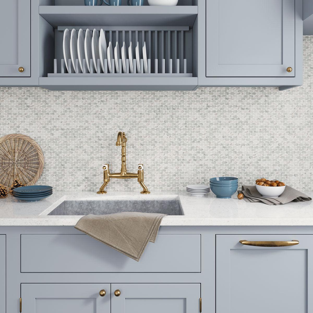 Blue kitchen cabinets with white marble tile kitchen backsplash