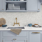 Blue kitchen cabinets with white marble tile kitchen backsplash