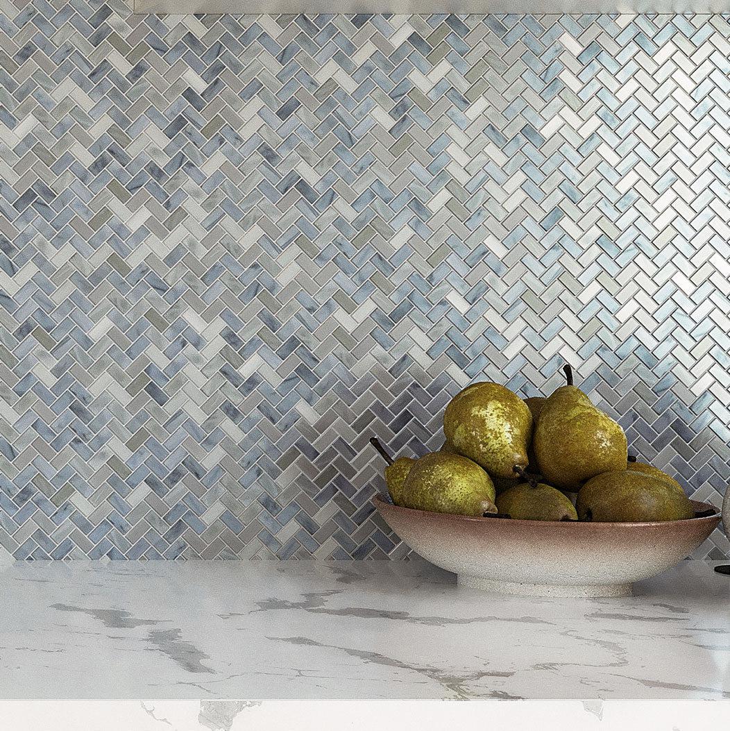 Plate with Fruit on a Background of Blue Pearl Herringbone Mosaic Tile Kitchen Wall