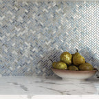 Plate with Fruit on a Background of Blue Pearl Herringbone Mosaic Tile Kitchen Wall