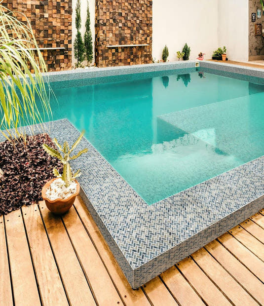 Outdoor Pool Tiled with Blue Pearl Herringbone Mosaic