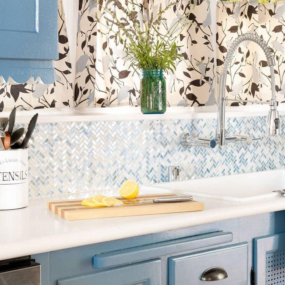 Vintage Coastal Kitchen with Blue Pearl Herringbone Mosaic Tile Backsplash and Repurposed Cabinets