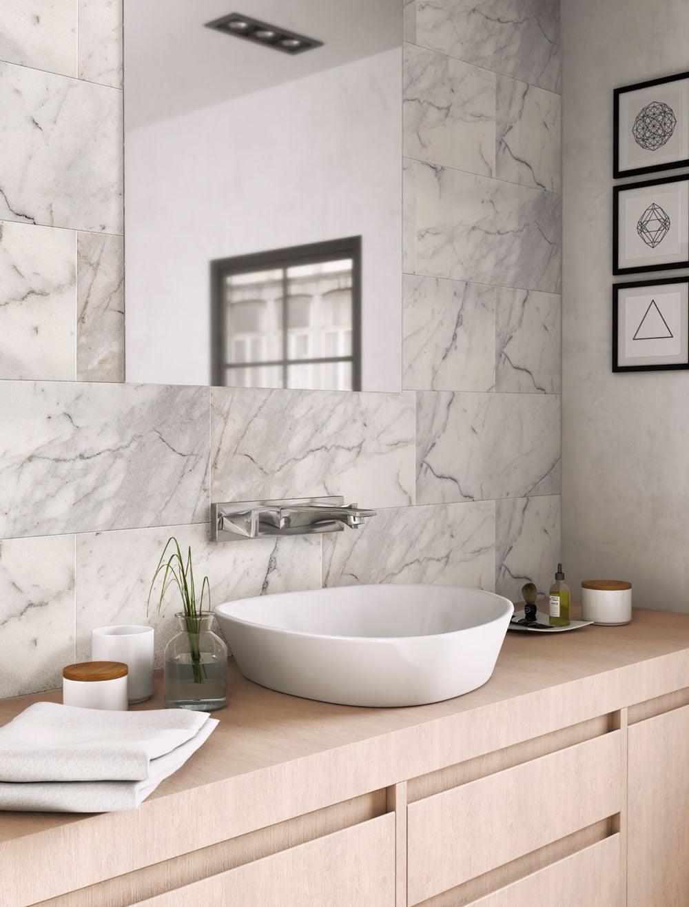 Calacatta Gold honed marble tiles with a minimalist wood bathroom