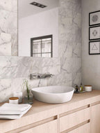 Calacatta Gold honed marble tiles with a minimalist wood bathroom