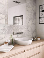 Calacatta Gold honed marble tiles with a minimalist wood bathroom