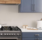 Relaxing cool gray kitchen and cream recycled glass basket weave mosaic tile kitchen backsplash