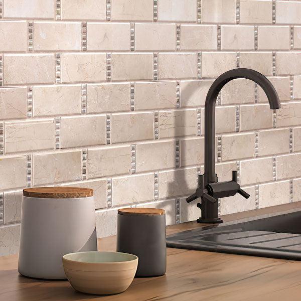 Kitchen Sink on Background of Crema Marfil Subway With Dot Marble Mosaic Wall