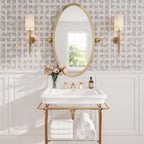 White and brass console sink with geometric marble tile walls for a wallpaper-inspired bathroom