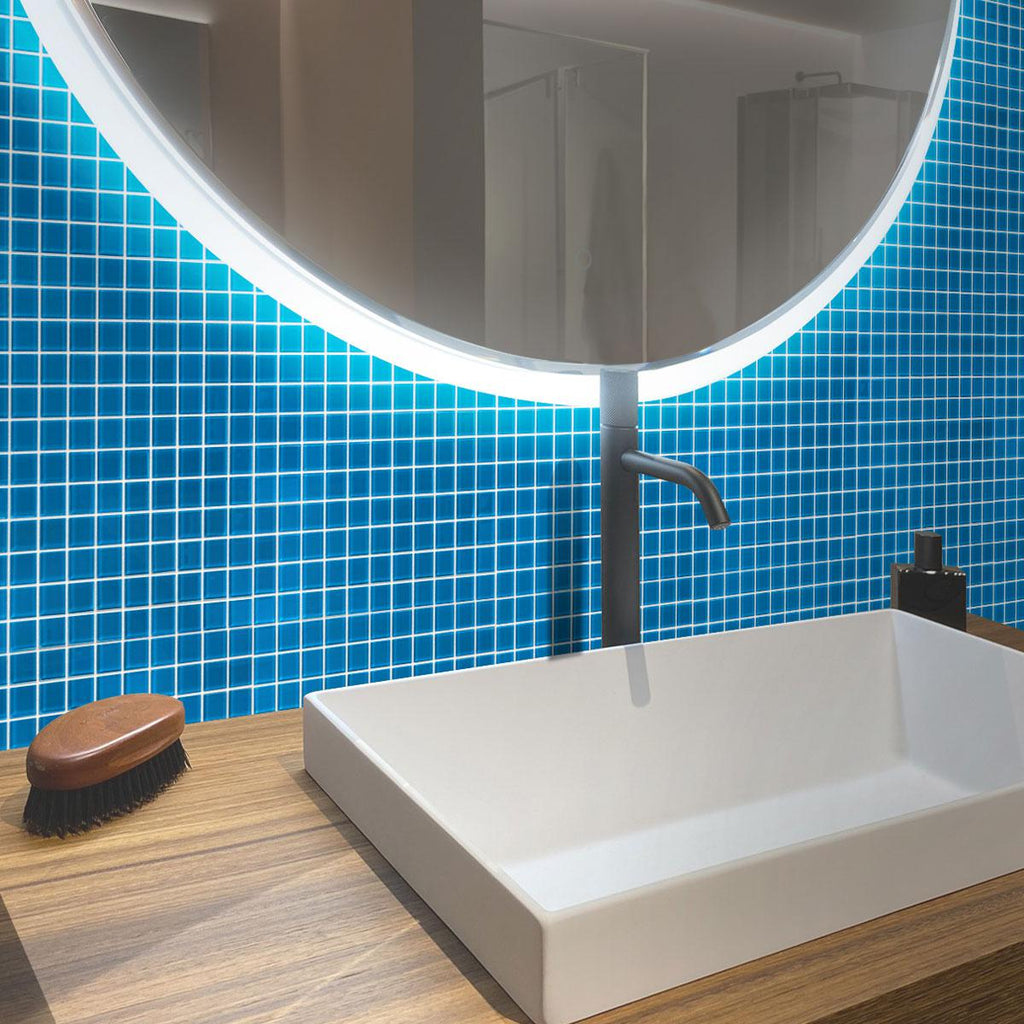 A serene bathroom featuring the shimmering Glacier Ocean Blue Polished Glass Tile