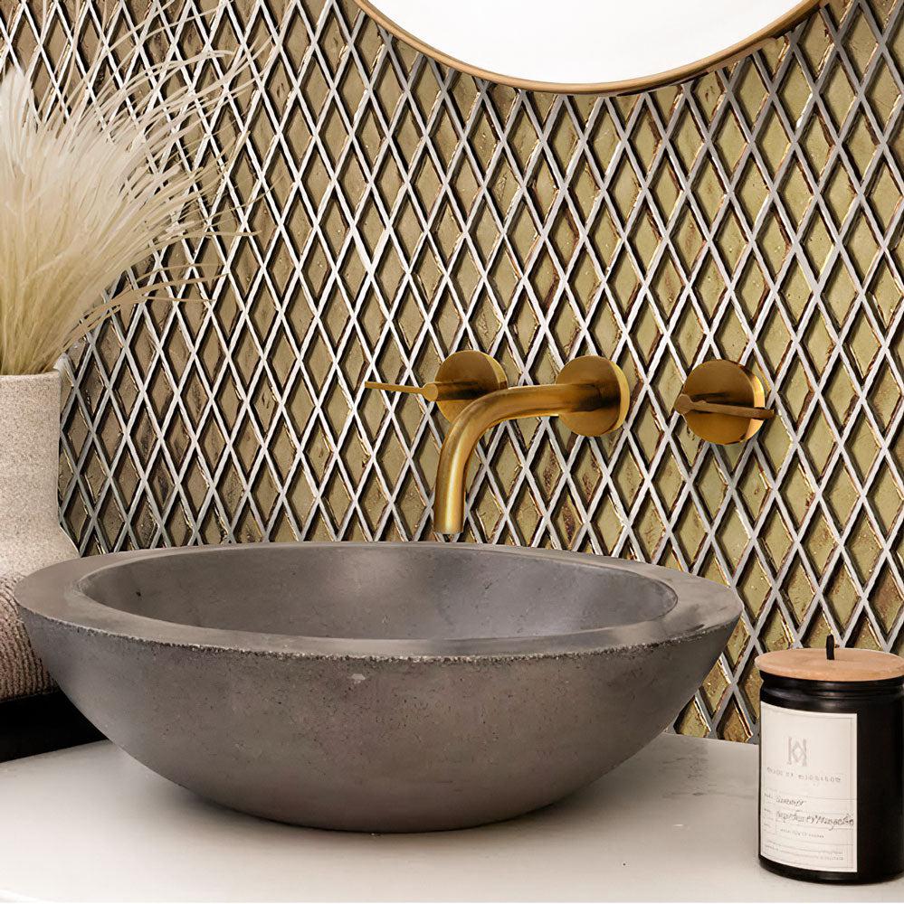 Washbasin sink made of concrete against the background of a Gold Diamond Glass mosaics wall