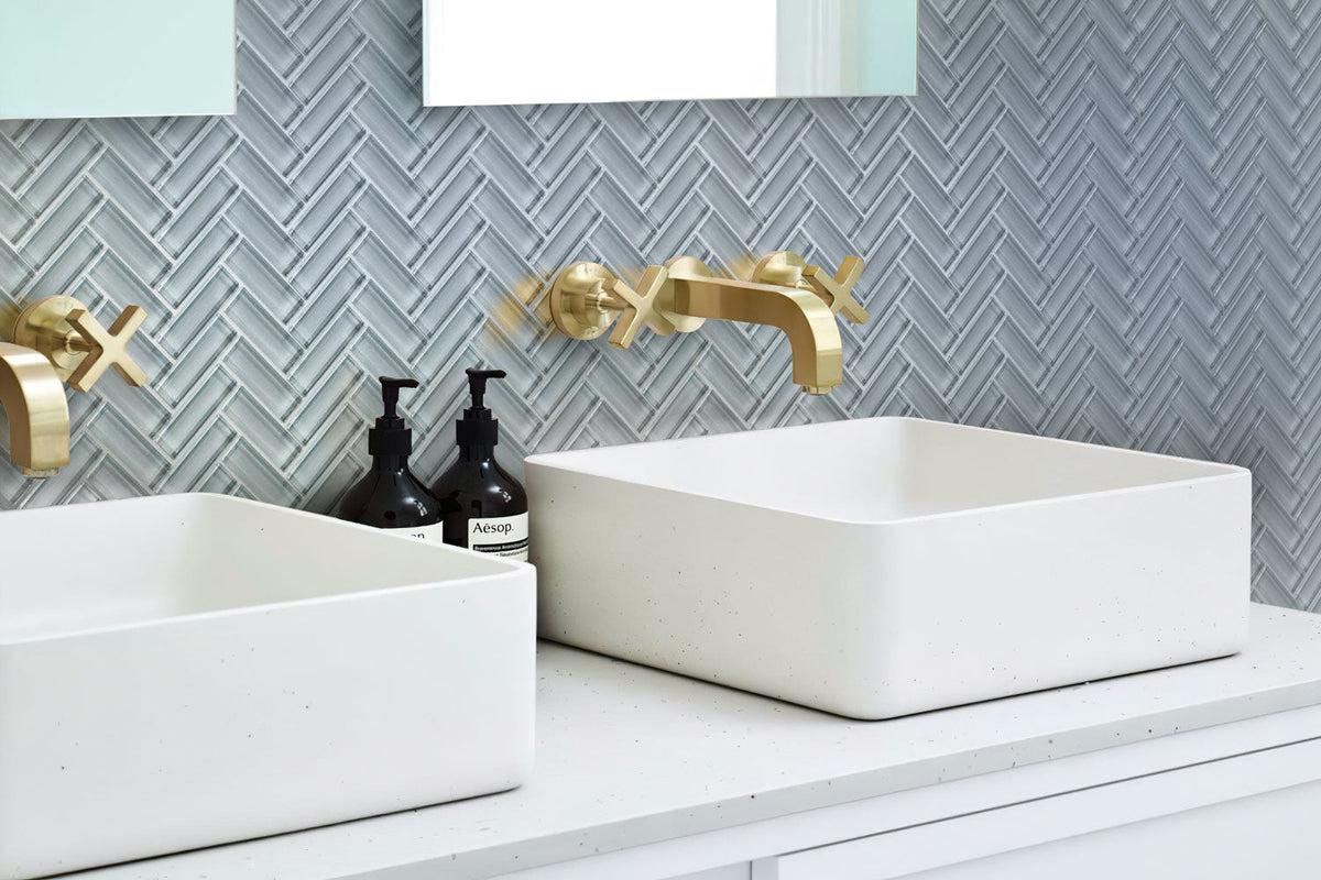 Gray Herringbone Glass Tile backsplash in bathroom with white porcelain wash basins