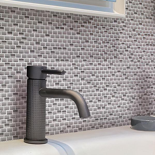 Sink in the Bathroom on Background of Grey Recycled Glass Brick Mosaic
