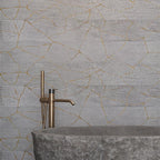 Bathroom made of wild stone on the background of the Kasai Fumo Kintsugi wall