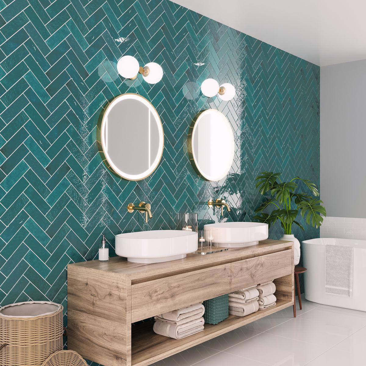 Green bathroom accent wall with ceramic subway tiles in a herringbone layout